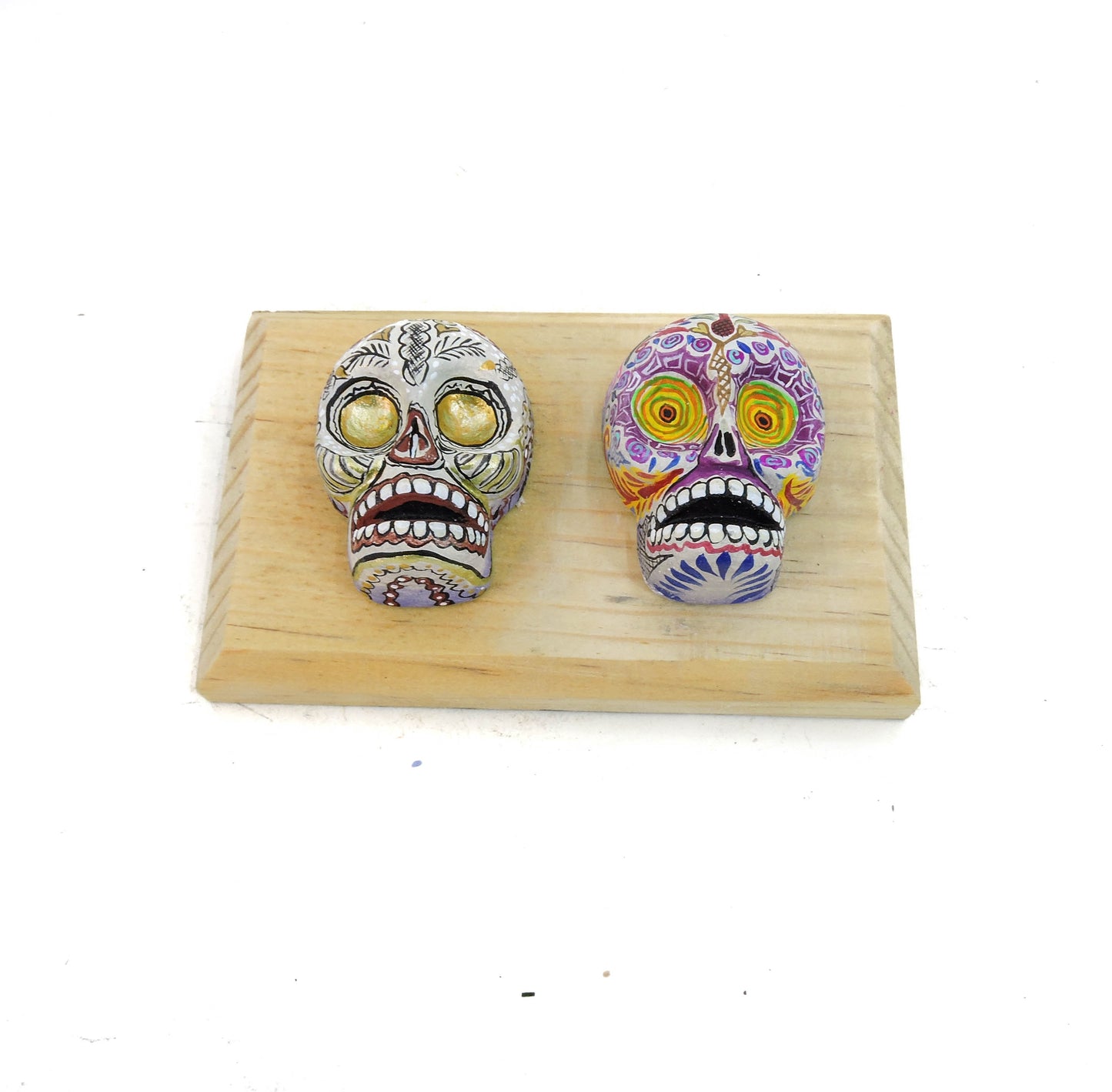 Colgante dos craneos colores